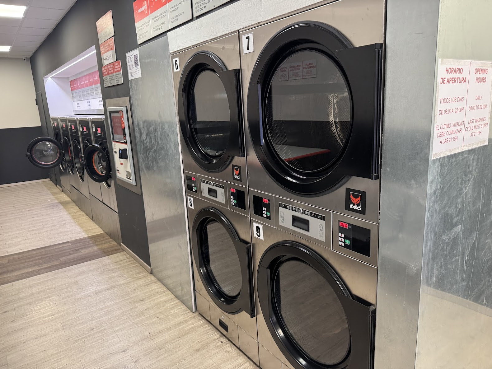 Speed Queen laundromat interior at Nou de la Rambla with row of washers and stacked dryers